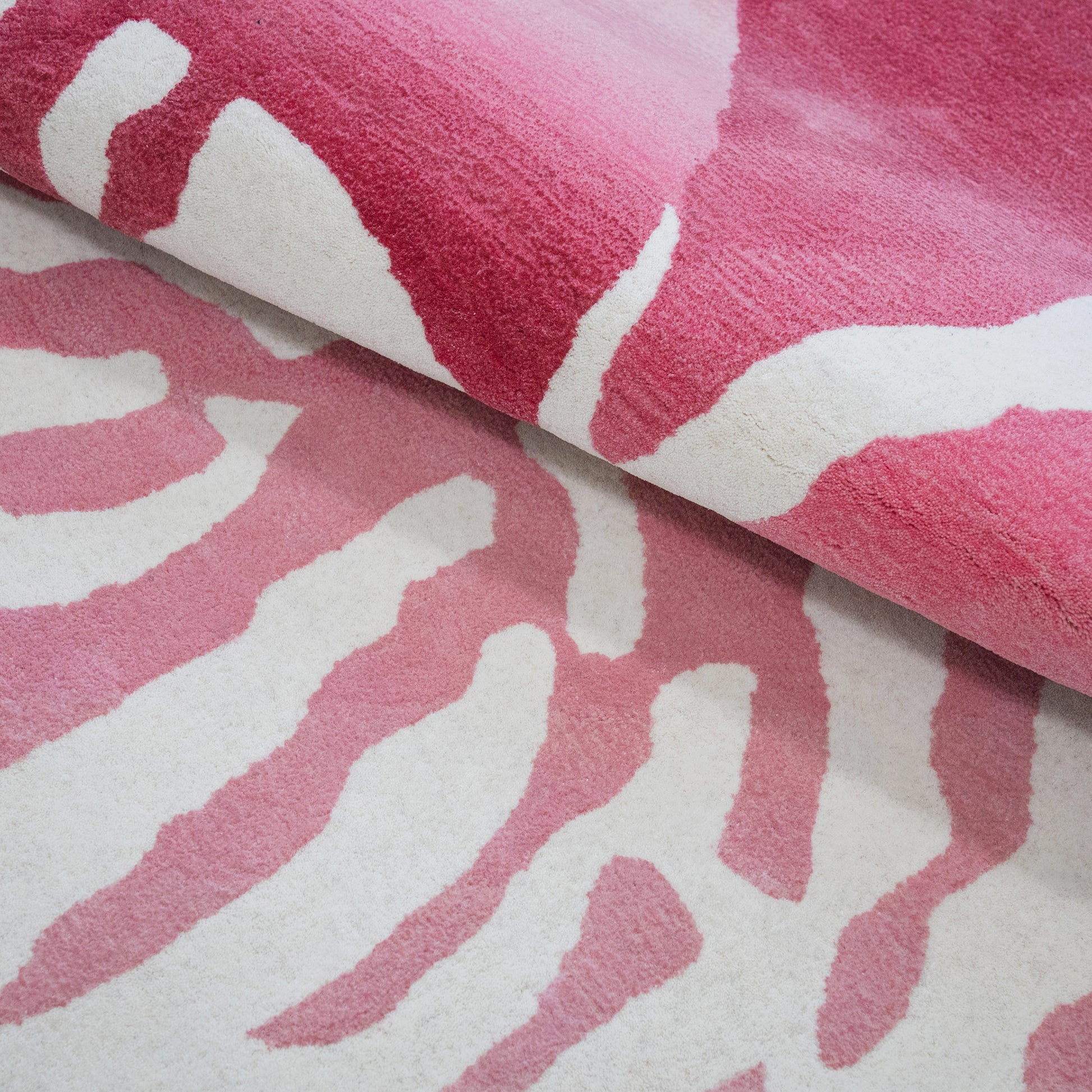Nautilus Pink Rug – hand-tufted pink shaped rug by Ohana